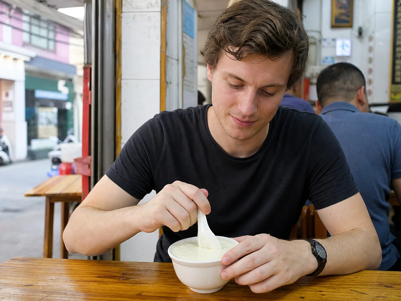 Traveler eating delicate custard