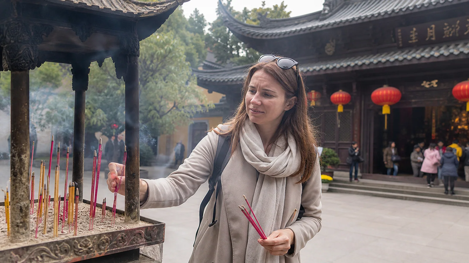 Visitor learning incense ritual in Wuxi