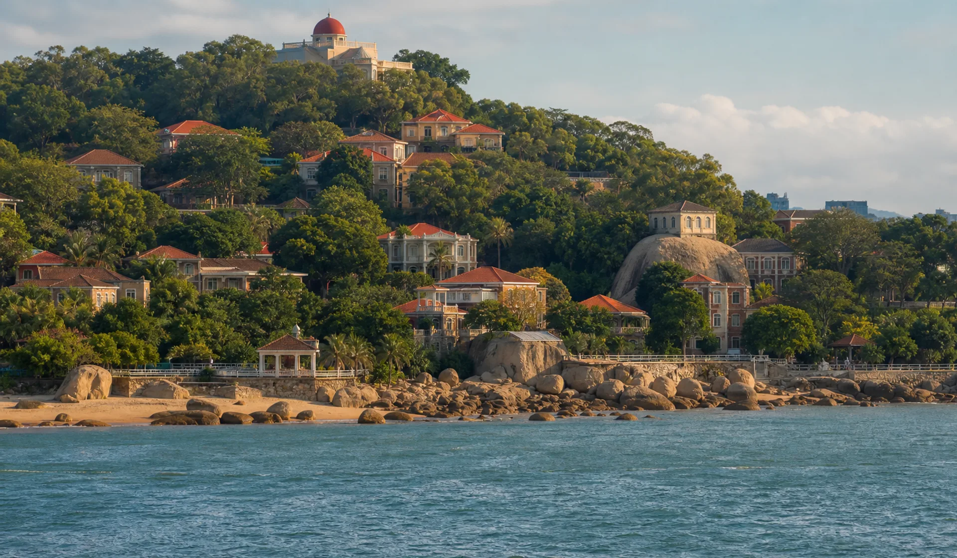 Gulangyu's red roofs, green trees, and shoreline seen across the water from Xiamen